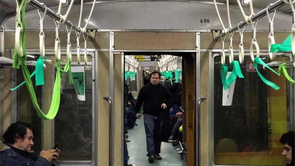 Green ribbons, which symbolize the abortion rights movement, are seen inside a subway train in Buenos Aires, Argentina, July 31, 2018.