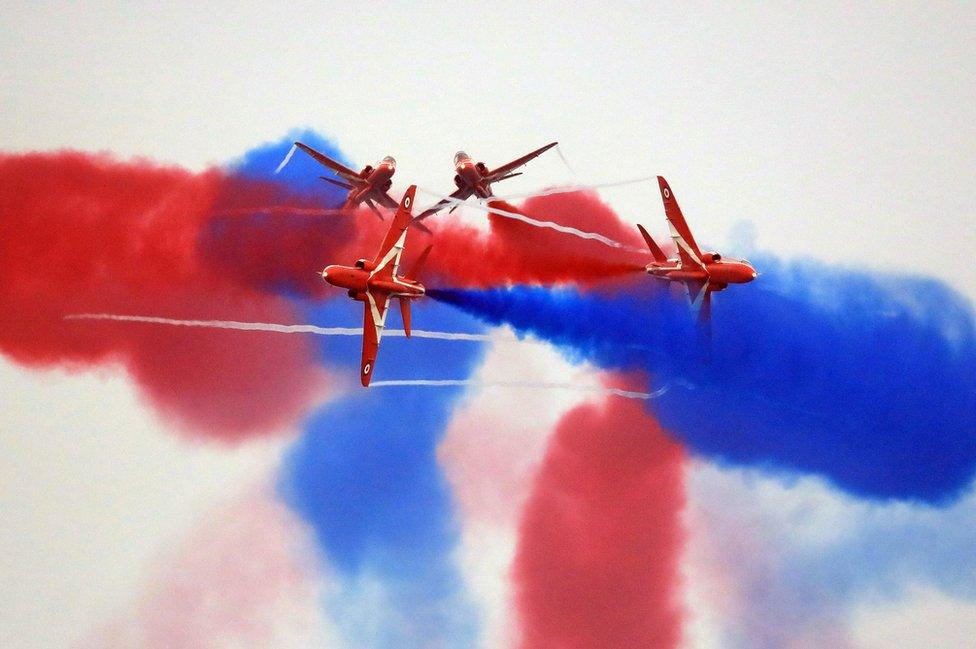 Red Arrows performing at the Sunderland International Airshow with coloured smoke in the sky