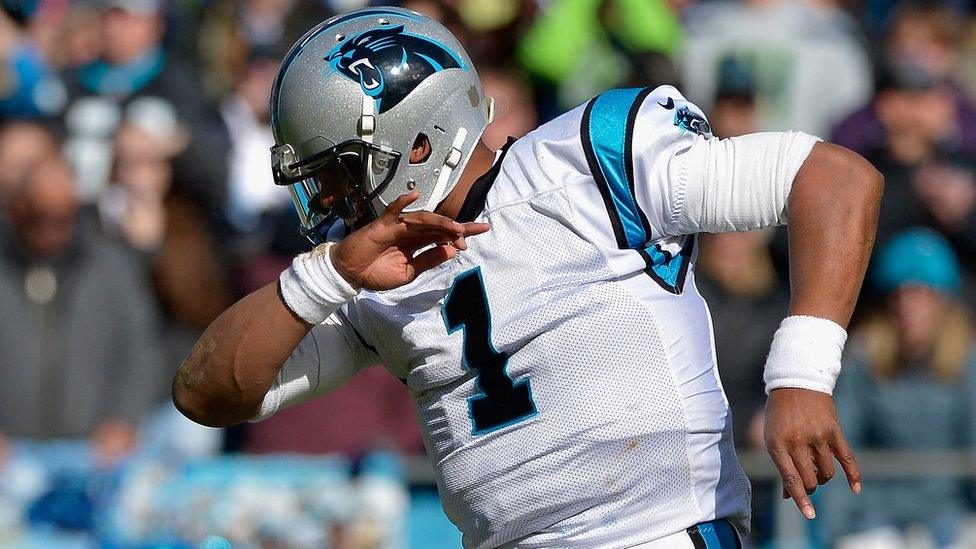 American footballer Cam Newton of the Carolina Panthers does the dab at the during an NFC game in Charlotte