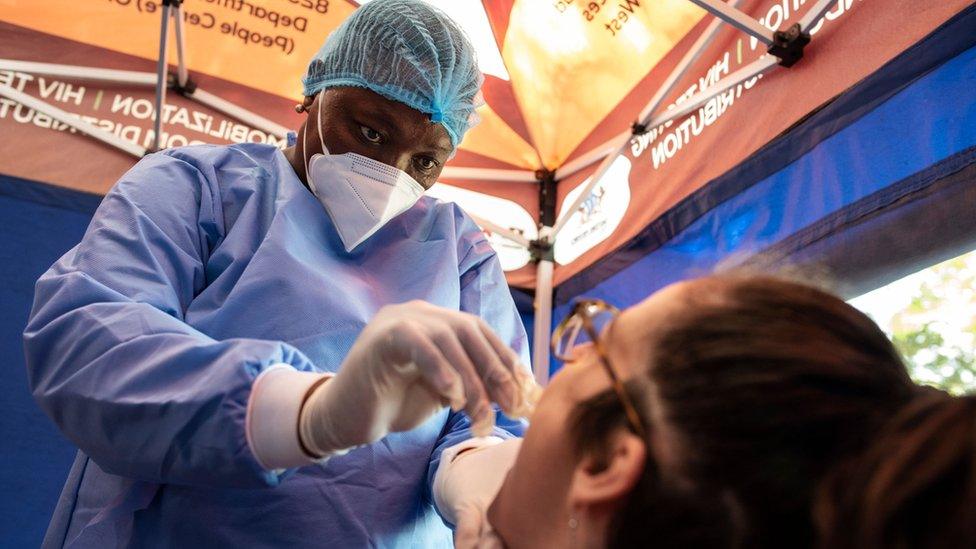 A health worker conducts a COVID-19 coronavirus molecular test in Parkview, Johannesburg, on October 22, 2020,