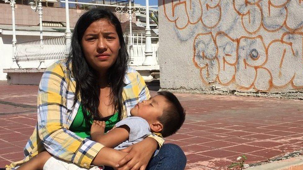 A mother and her sleeping son in the Mexican border town of Tijuana, 29 April 2018