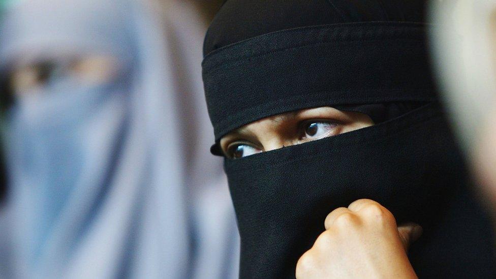 A Muslim woman with a veil attends the 'A woman's right to choose' conference on 12 July 2004 in London. T