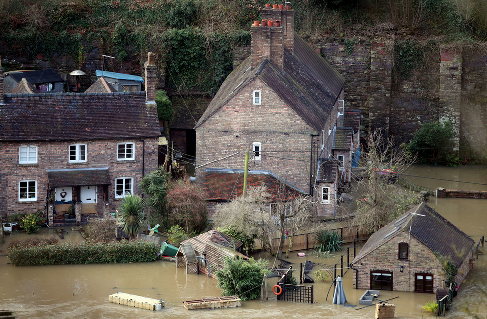 The Vic Haddock boat house (right) under water on the River Severn