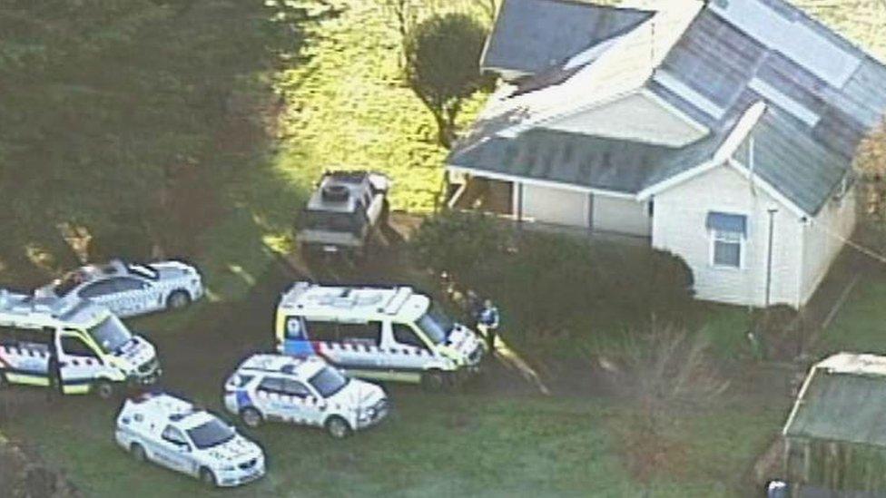 Police and ambulance vehicles outside the house where the dog attack took place