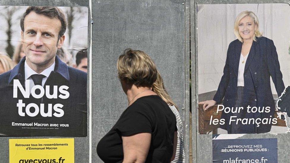 Image shows Macron and Le Pen poster