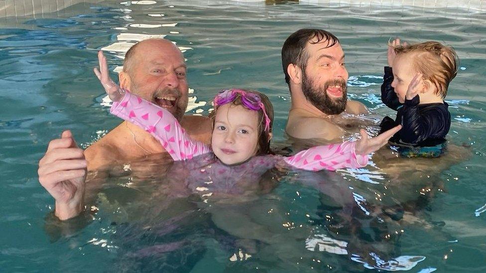 Ross Cunliffe with his son and grandchildren in a swimming pool