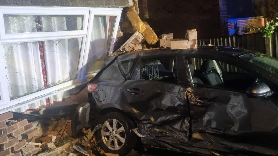 Car crashed into house