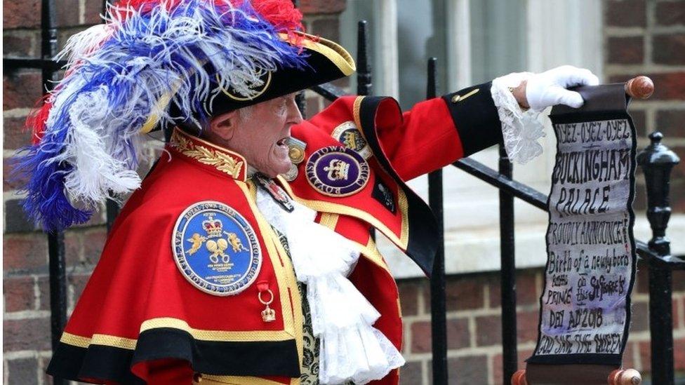 Town cryer with scroll announcing birth