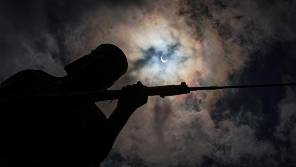 Moon moves to cover the sun for a annular solar eclipse behind the 'Askari monument' in Dar es Salaamon 1 September 2016