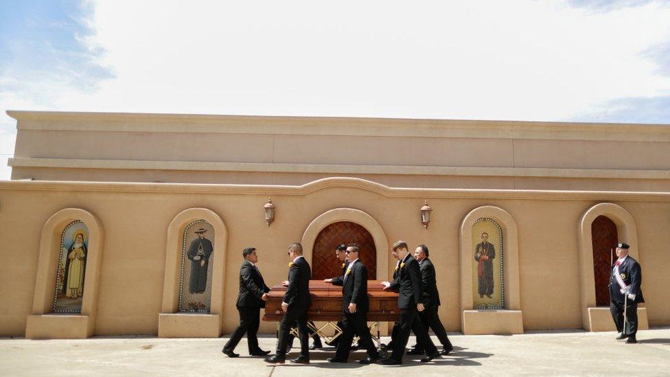 Pallbearers wheel the casket of Angelina Englisbee, 86, who lost her life in the El Paso mass shooting at Walmart