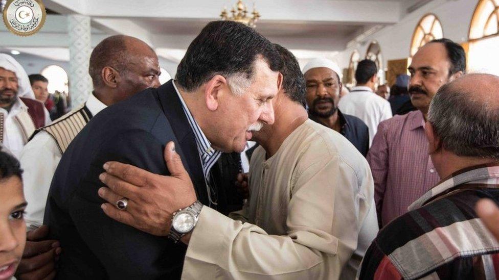 Fayez al-Sarraj being greeted at a mosque in Tripoli