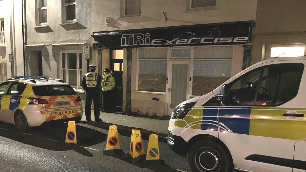 Police standing outside a property on Upper Market Street