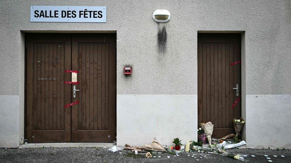 Flowers outside the hall where a 16 year-old was murdered on 19 November