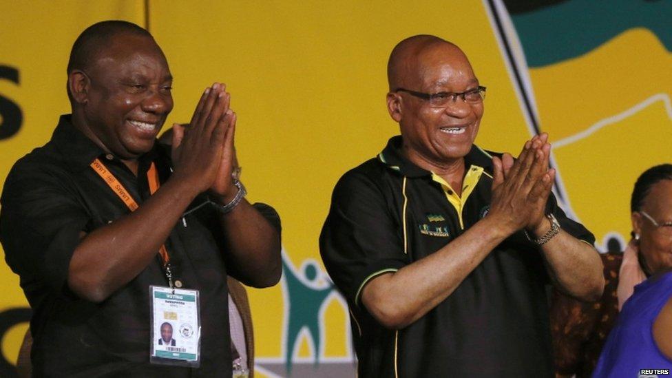 South Africa's President Jacob Zuma celebrates his re-election alongside newly-elected party Deputy President Cyril Ramaphosa