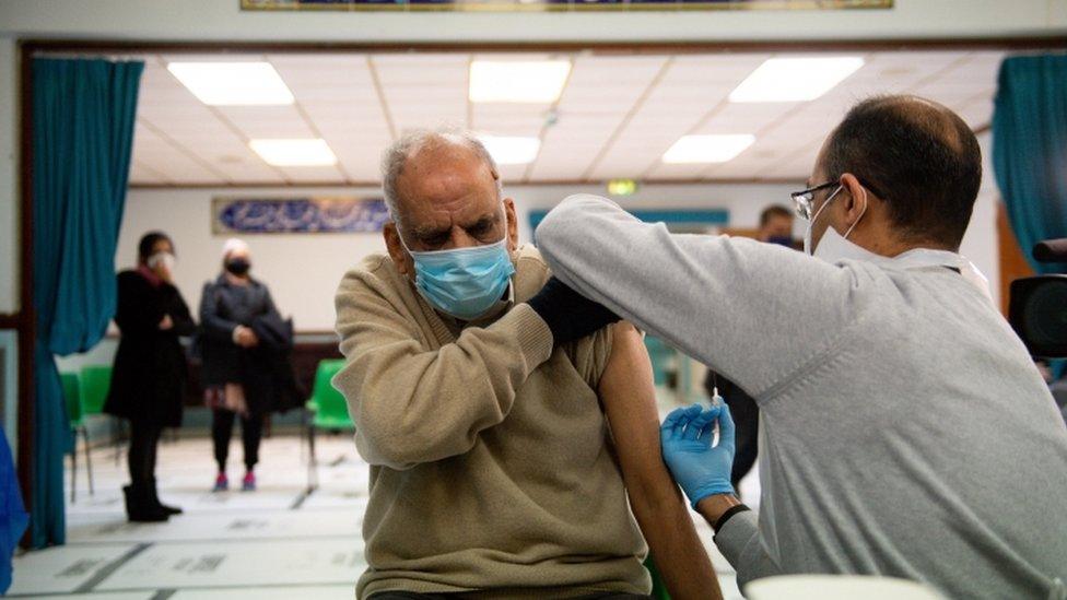 Masud Ahmad, 79, receives an injection