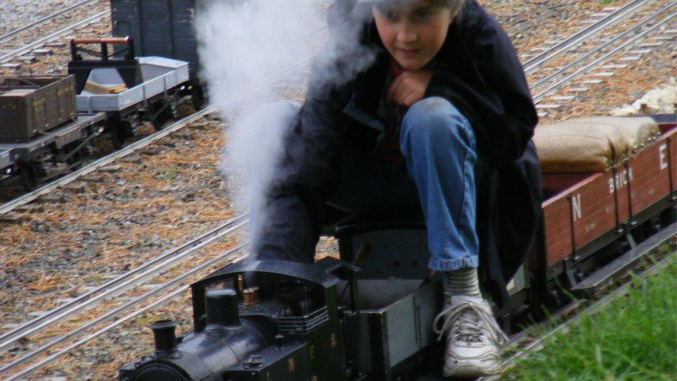 Joe Waddington riding a miniature locomotive