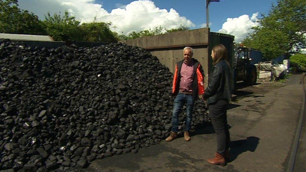 Paul Townsend and the BBC's Claire Starr looking at a pile of coal by the railway