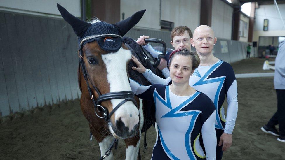 Antinisca, Alberto and Michele standing by the side of a horse