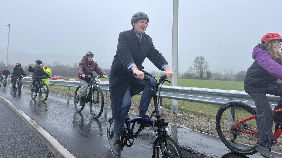 Deputy Climate Change Minister Lee Waters joins children crossing the bridge