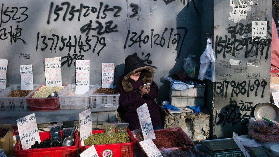 A vendor waits for clients on a market in Beijing