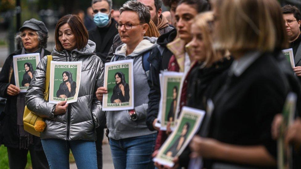 People in Krakow, Poland hold banners