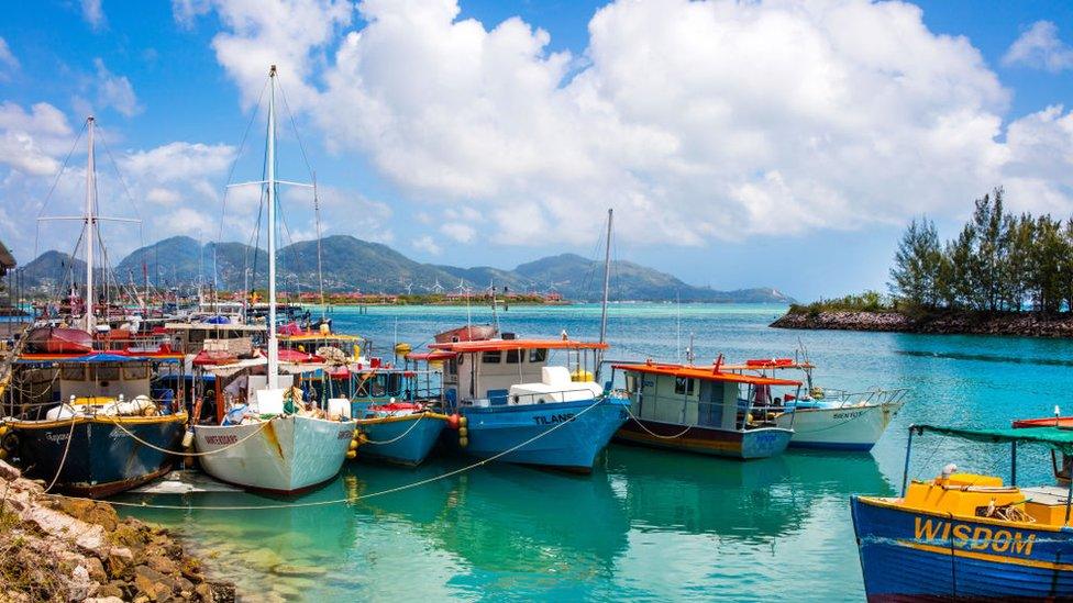 Boats moored by an island in the Seychelles