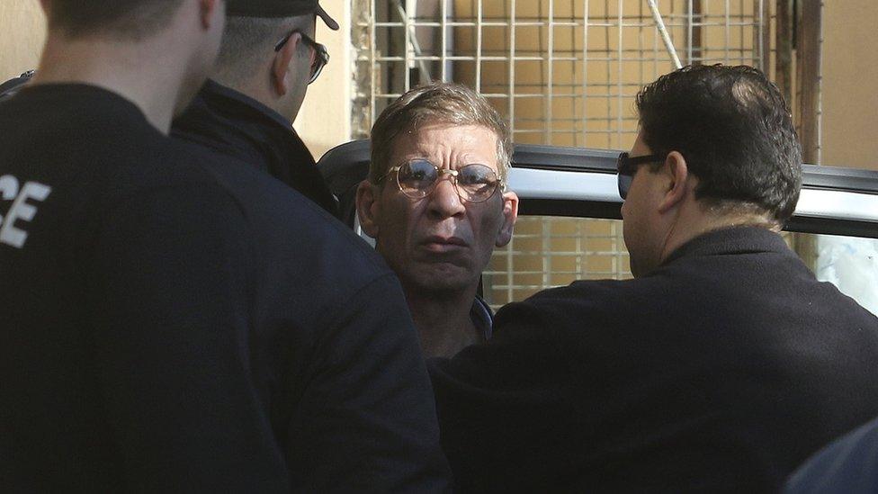 Suspect being transferred by Cypriot police to a court in the city of Larnaca.