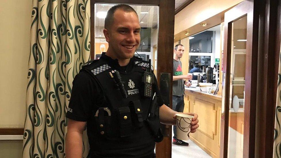 A police officer with a cup of tea at the Rugby count