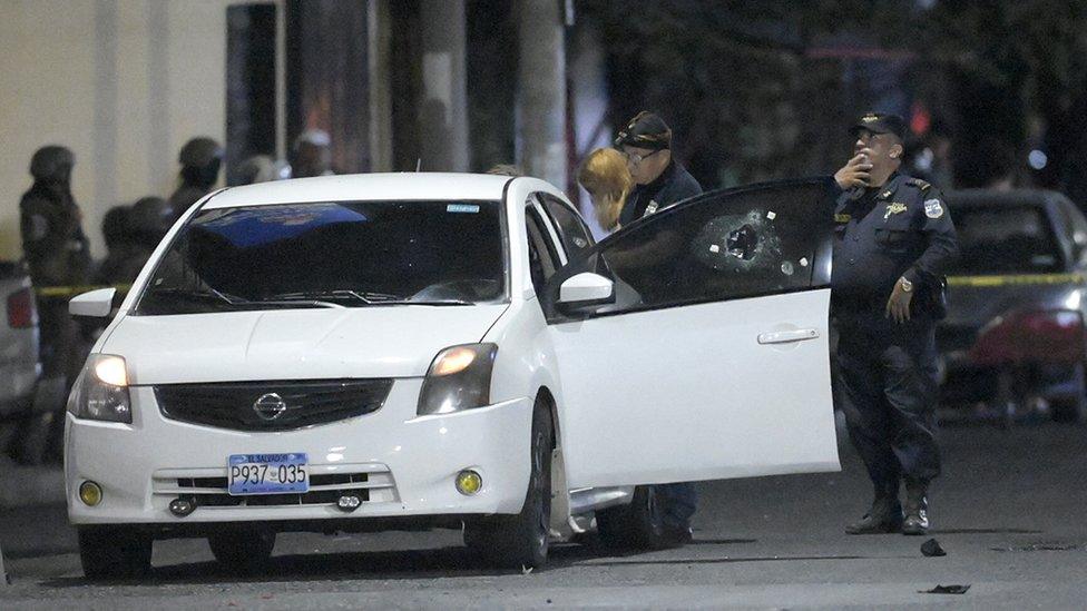 Police at the scene of where a man was killed by alleged gang members in Colón, La Libertad department, El Salvador on 26 March, 2022