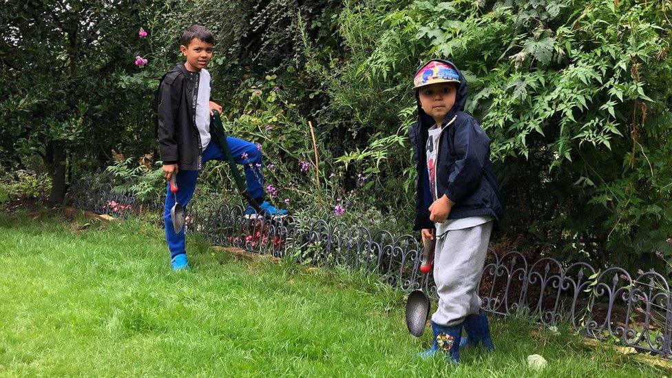 Alexander and Isaac looking after their garden