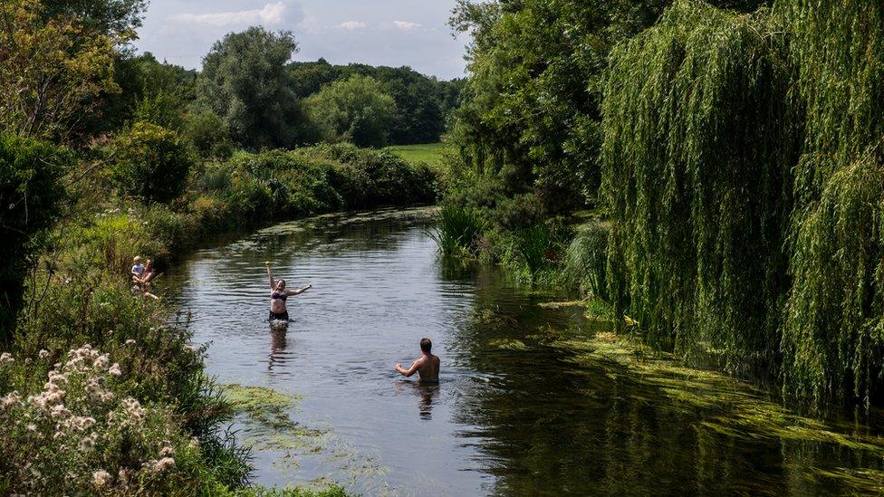 People play in a river