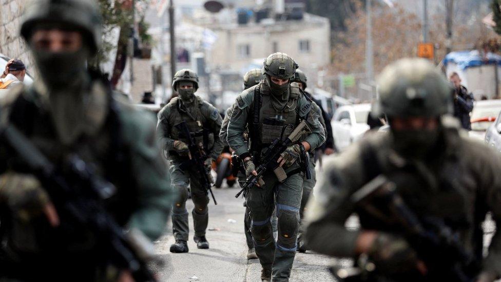 Israeli security personnel work at a scene where a suspected incident of shooting attack took place