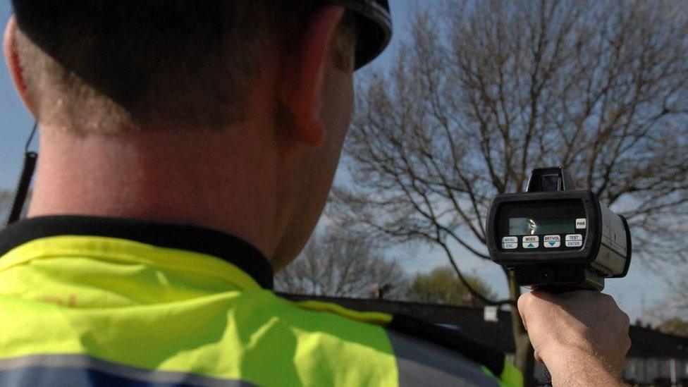 Person holding a speed camera