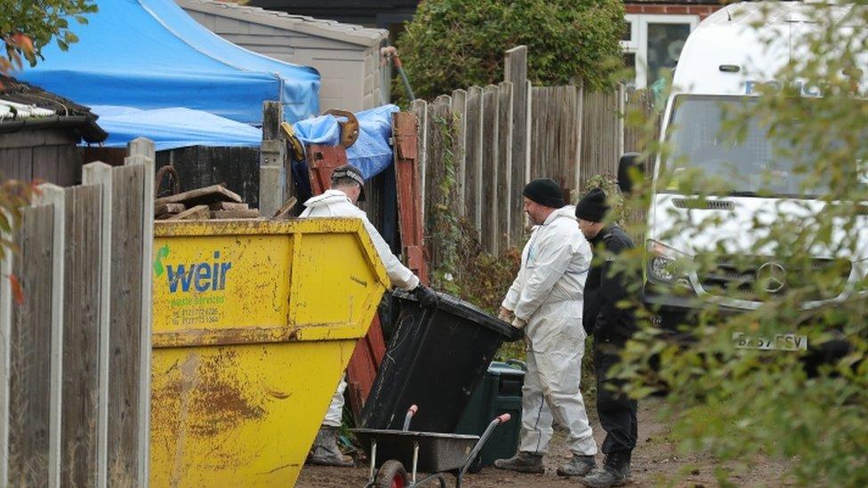 Police officers work at the rear of a property on Shipton Road in Sutton Coldfield