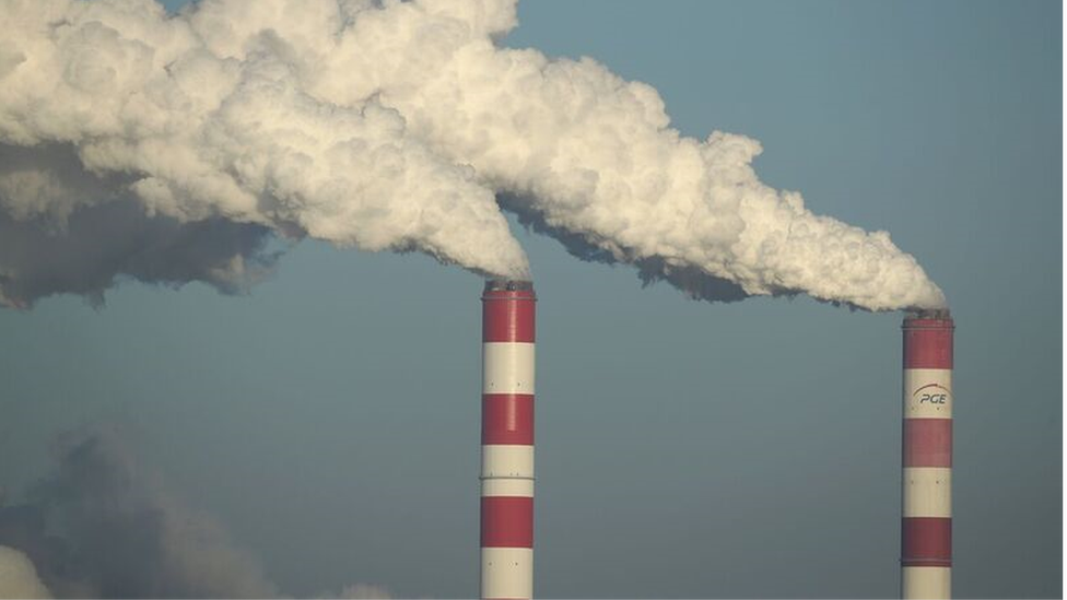 A coal plant with smoke rising into the air