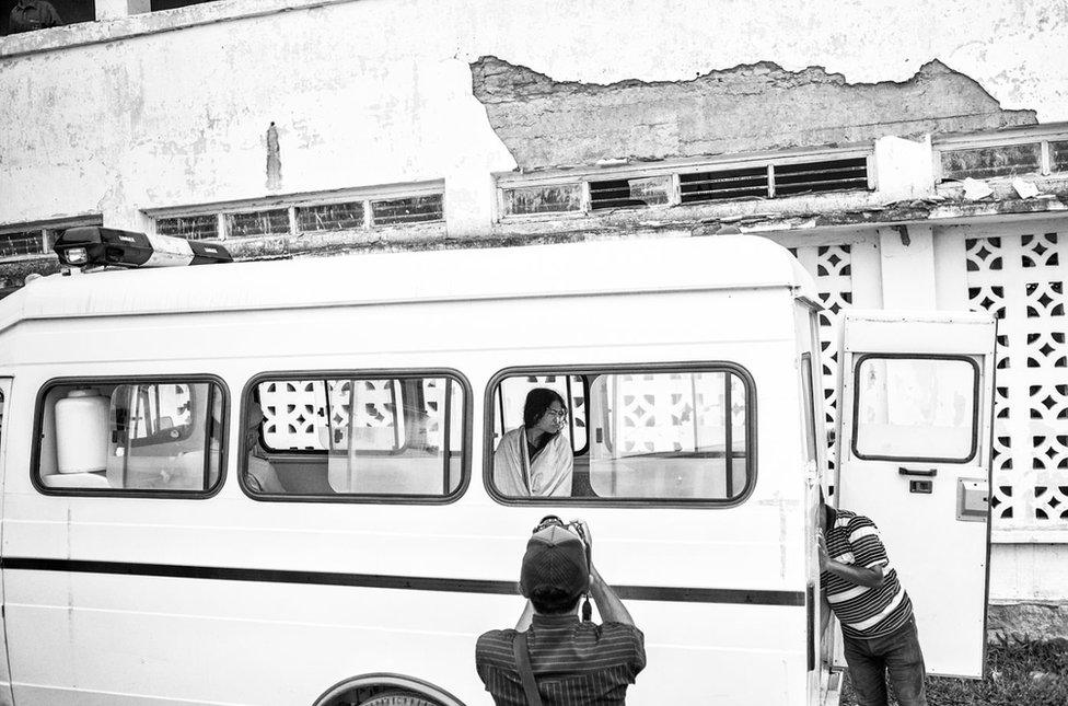 Irom Sharmila Chanu, commonly know as Sharmila or "the Iron Lady of Manipur," waits to be transported back to the secure wing of the Jawaharlal Nehru Institute of Medical Sciences Hospital (JNIMS) in a Imphal police van after appearing for her bi weekly hearing at the Manipur High Court in Imphal, Manipur in India's North East, to reaffirm her now 14 year fast against the Armed Forces Special Powers Act, in-front of the court. Every 14 day Sharmila must reaffirm, in front of the court, her desire to continue her fast, and every 14 days the courts rule that she is attempting to commit suicide and is then remanded to the secure wing of JNIMS. June 13, 2013.