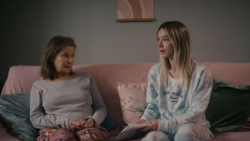 Stephanie Beacham as Peg sitting on a sofa next to Eloise Smith, who plays her grand daughter Chloe