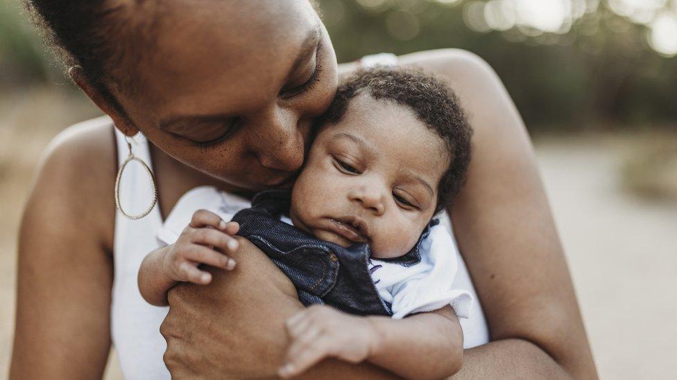 A woman holding a baby