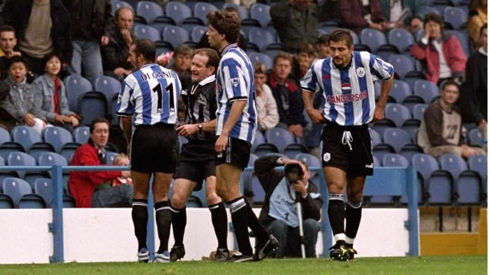 Paolo-Di-Canio-surrounded-by-teammates.