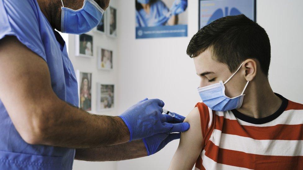 teenager being vaccinated