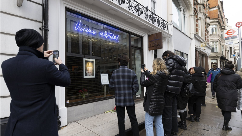 People gather outside a Vivienne Westwood store in London