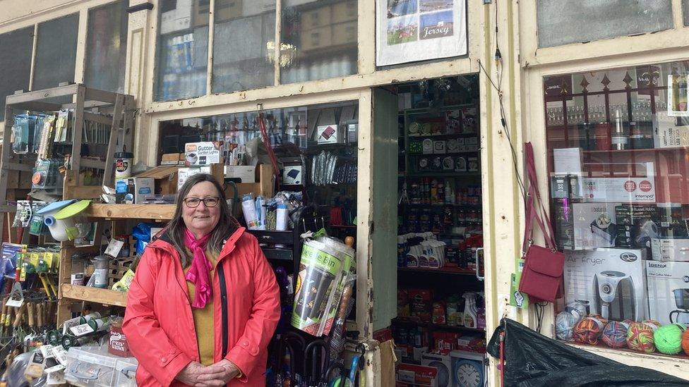 Sheila Baudains outside shop