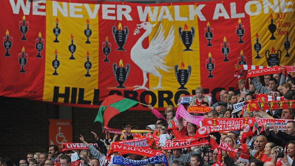 Peter Carney's We Never Walk Alone banner hangs from a stand at Anfield during the memorial service on 15 April 2009 to mark the 20th anniversary of the Hillsborough disaster