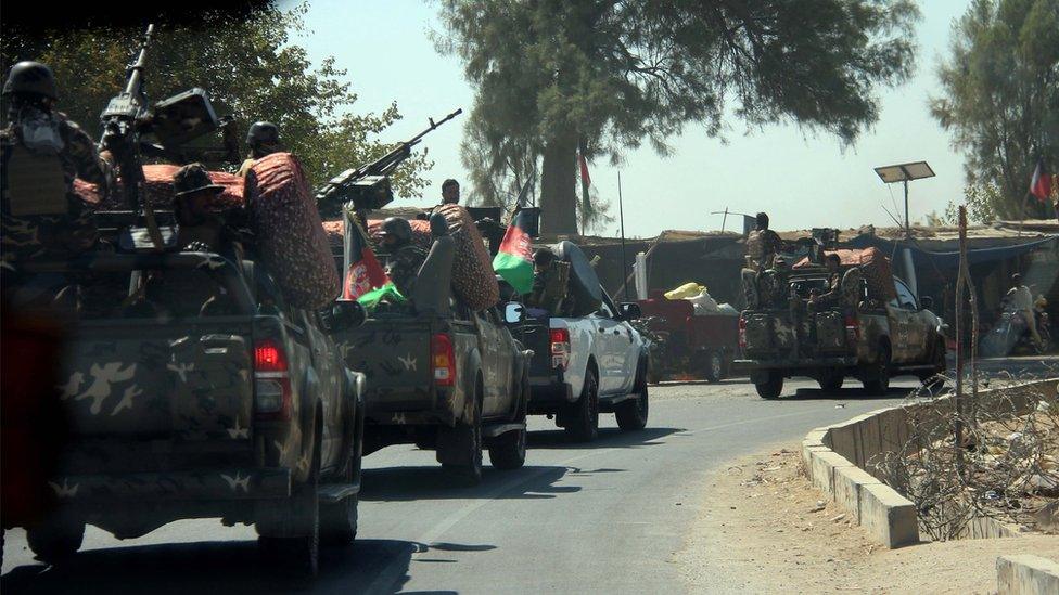 Afghan security officials patrol on Helmand-Kandahar highway after the Taliban launched its first largescale attack on the capital of south-western Helmand province in Afghanistan