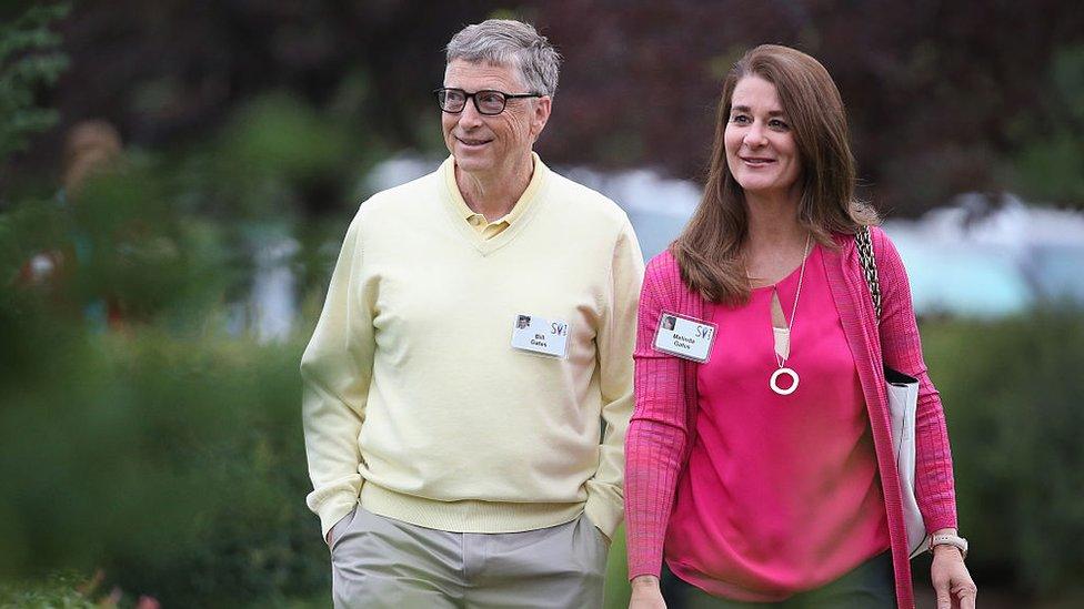 Bill and Melinda Gates walking through garden area at 2015 event