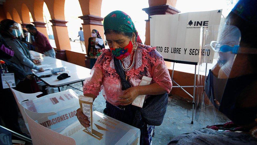 An indigenous Zapotec woman casts her vote at a polling station during the mid-term elections in the rural village of San Bartolome Quialana