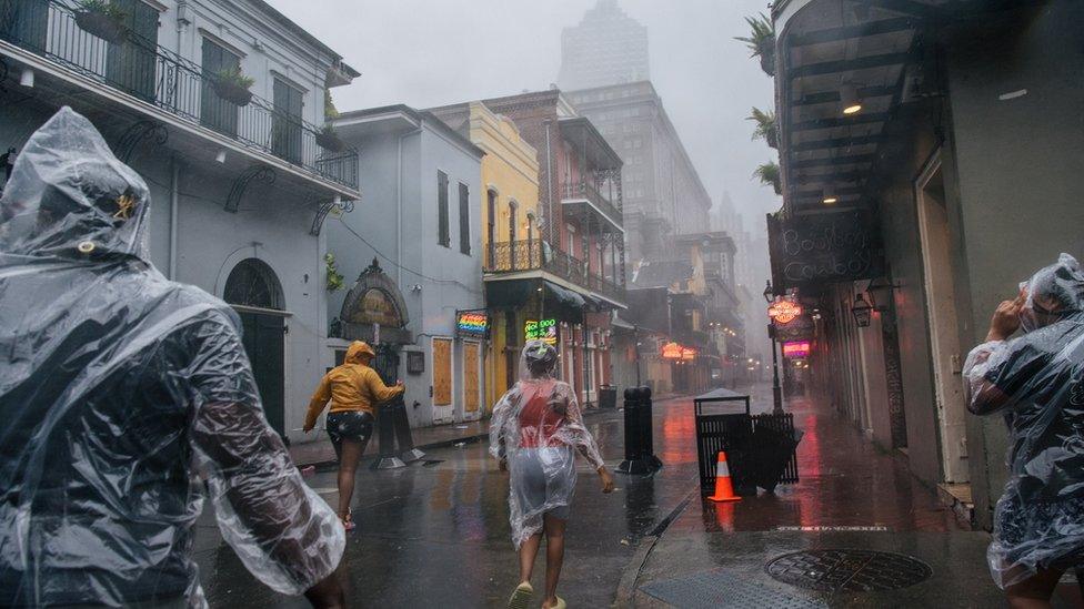 People walk through the French Quarter in New Orleans on Sunday