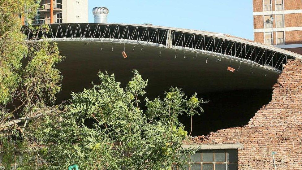 The roof of a sports centre in the port city of Bahia Blanca seen partially collapsed after a storm.