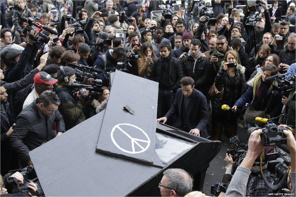 A man has brought his portable grand piano to the Bataclan Theatre where he's been playing John Lennon's Imagine