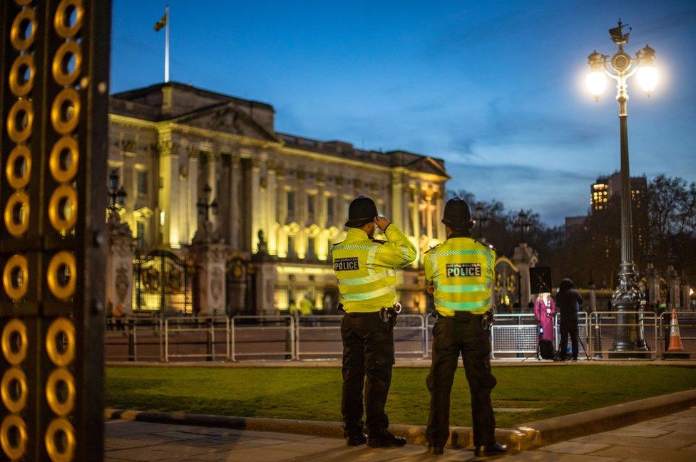 Police stand at Buckingham Palace